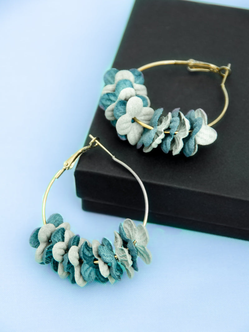 blue flower petals threaded along a gold 2" hoop earrings