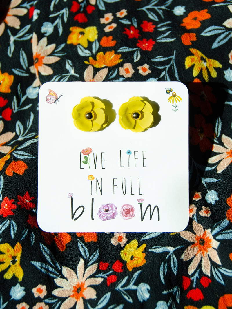 Yellow floral stud earrings on a 3.5x 3.5 card.  packaged in a black gift box